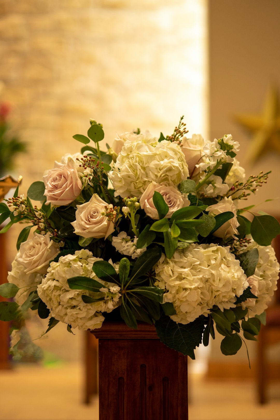 a-vase-filled-with-white-flowers-on-top-of-a-table-td8vyvg7ybw